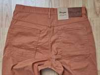 Nowe pomarańczowe spodnie męskie jeans Wrangler Arizona W31l34