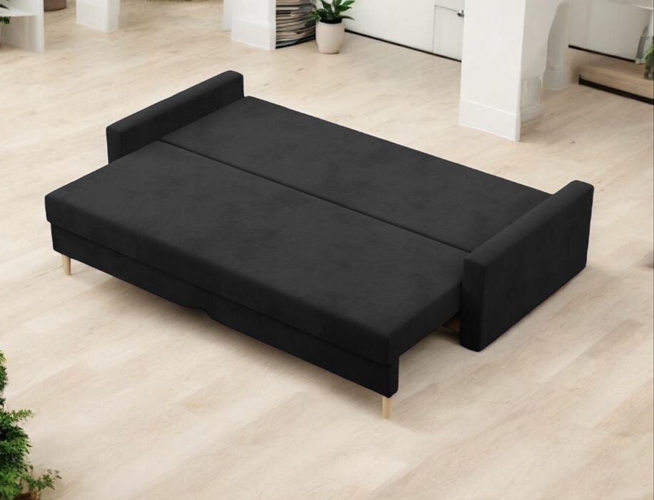 Używana czarna sofa rozkładana z funkcją spania pojemnikiem. Transport