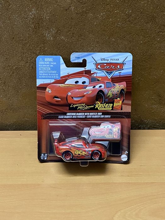 Cars - Lightning McQueen with rusteze sign Disney Pixar