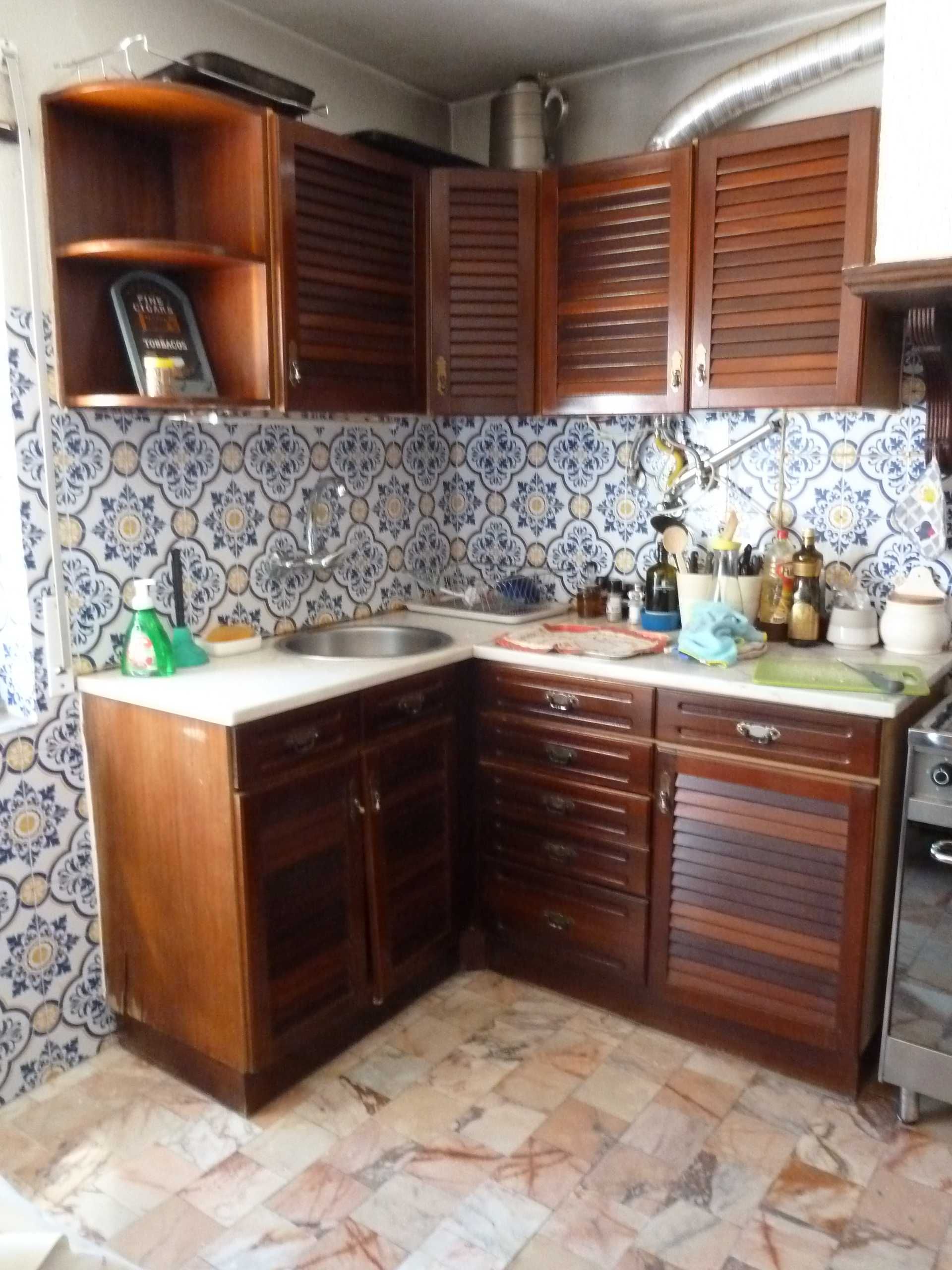 Cozinha com armários em madeira maciça e tampos em mármore