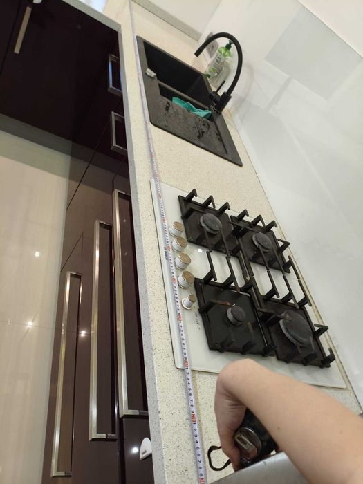 Zabudowa kuchenna wraz ze zmywarką, płytą gazową i piekarnikiem.