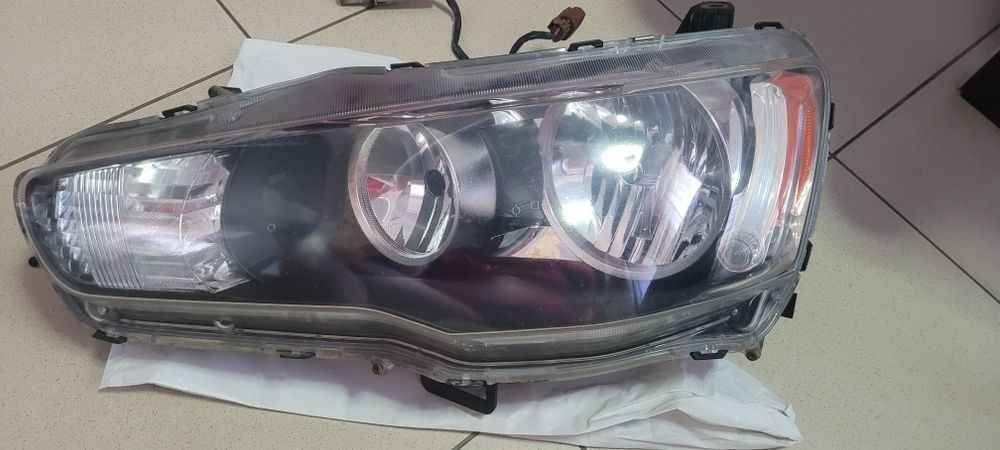 Фара передня ліва оригінал Lancer 2008 8301B259