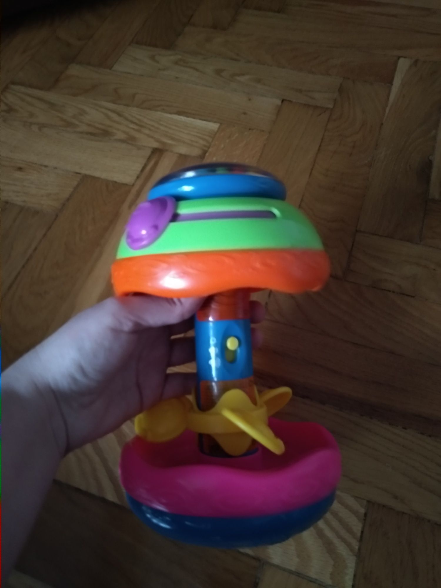 Grzechotka zabawka brzęczek Fisher Price kołowrotek z melodyjki