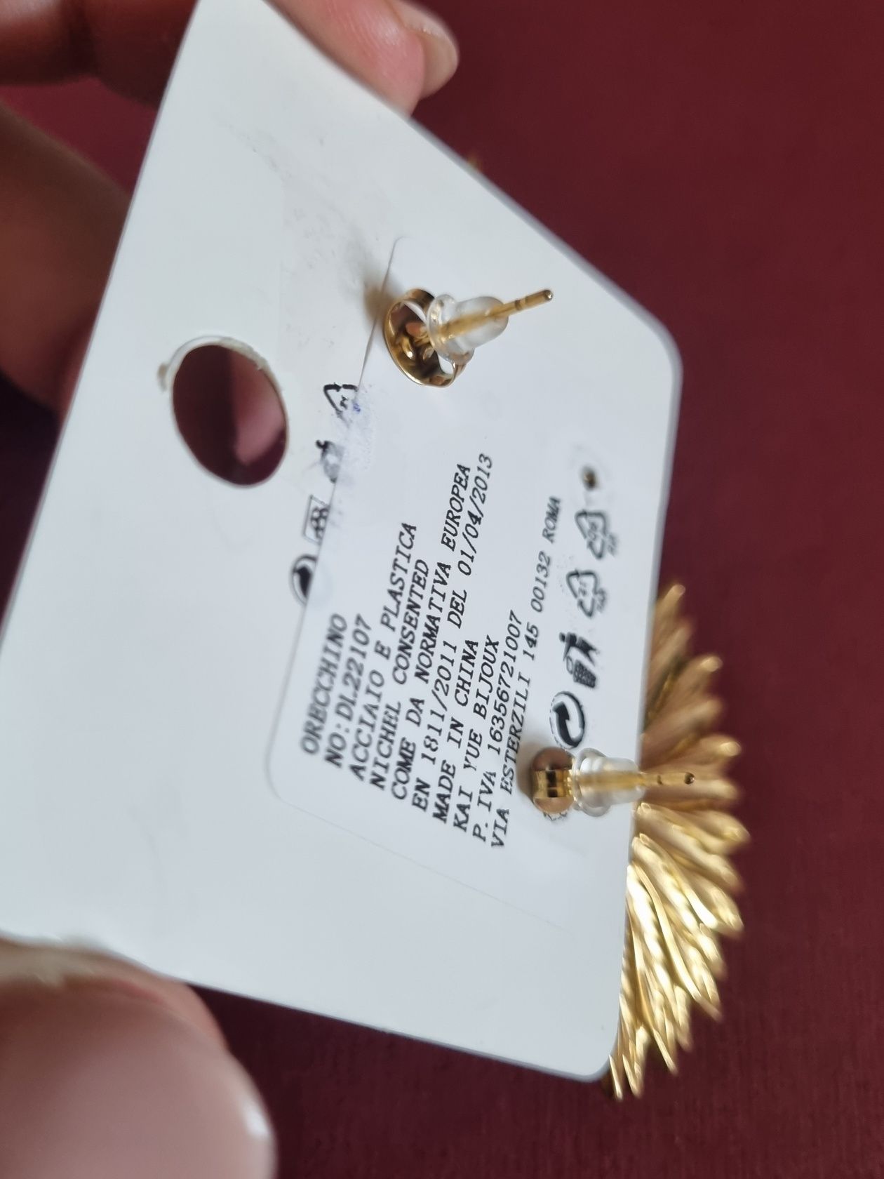 Brincos dourados, em aço, com apontamento beringela. De pico