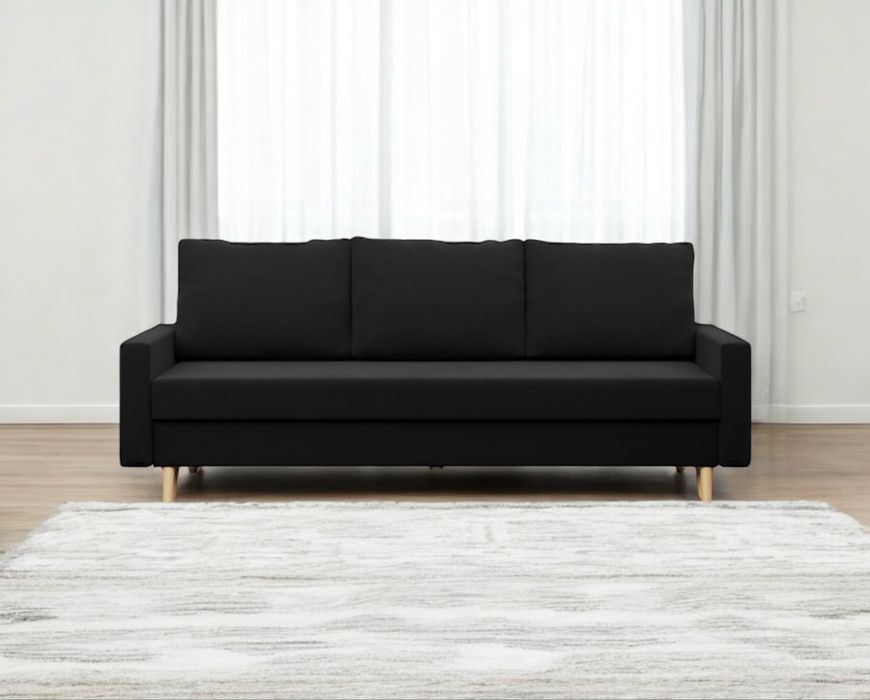 Używana czarna sofa rozkładana z funkcją spania pojemnikiem. Transport