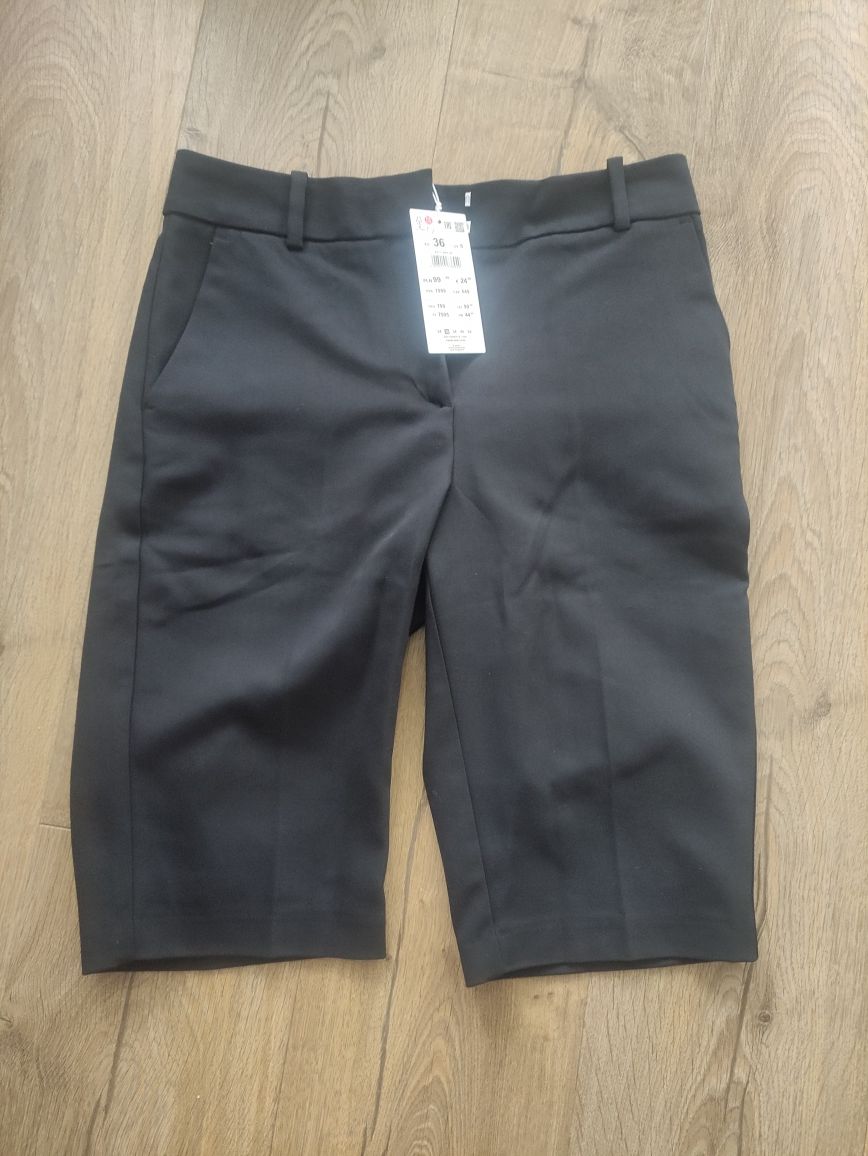 Nowe czarne materiałowe eleganckie shorty do kolan