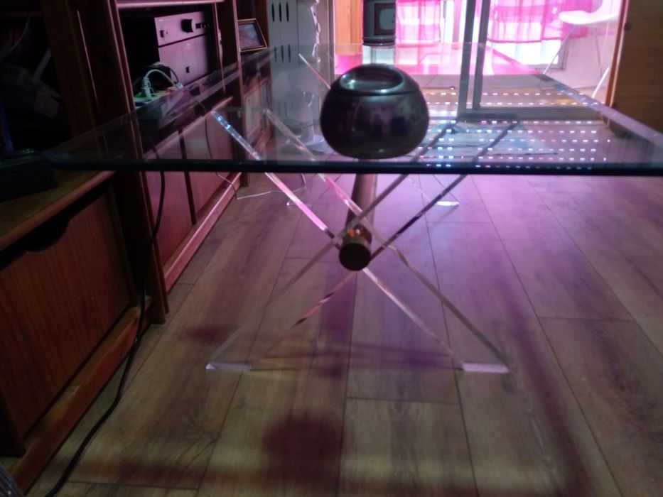 Mesa de centro com tampo em vidro.