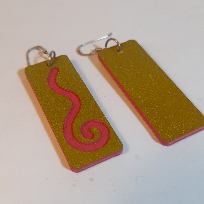 Wooden earrings with spiral design.