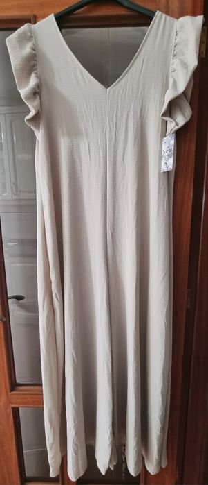 Macacão bege comprido, com folhos nos ombros. TU