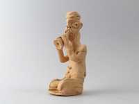 surowa ceramiczna figura figurka grający na flecie