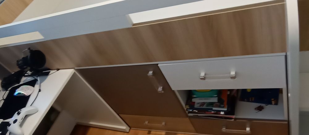 Łóżko dziecięce z szafką, szufladami, półkami i biurkiem.