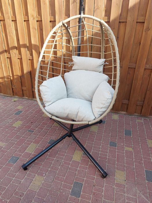 Fotel wiszący na stalowej podstawie z poduszką.