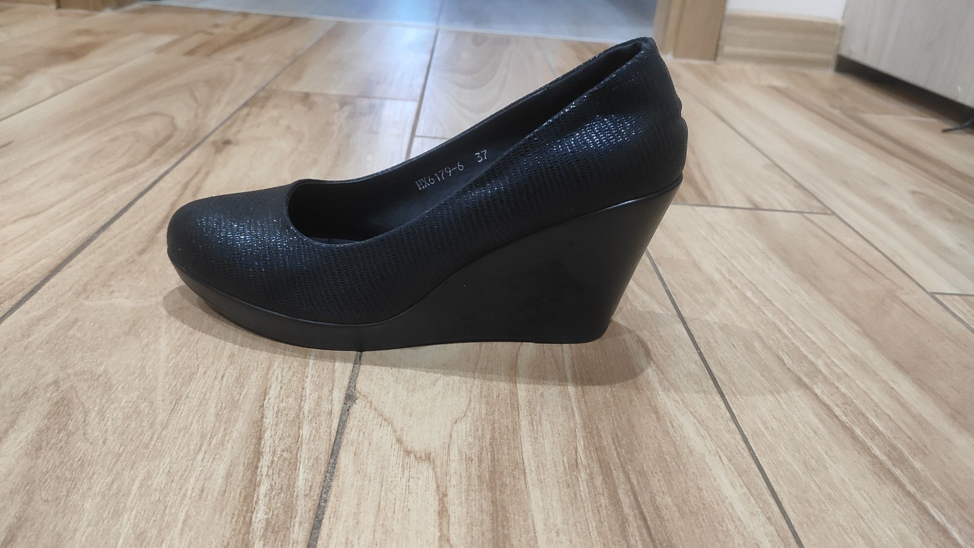 Buty czarne na koturnie.