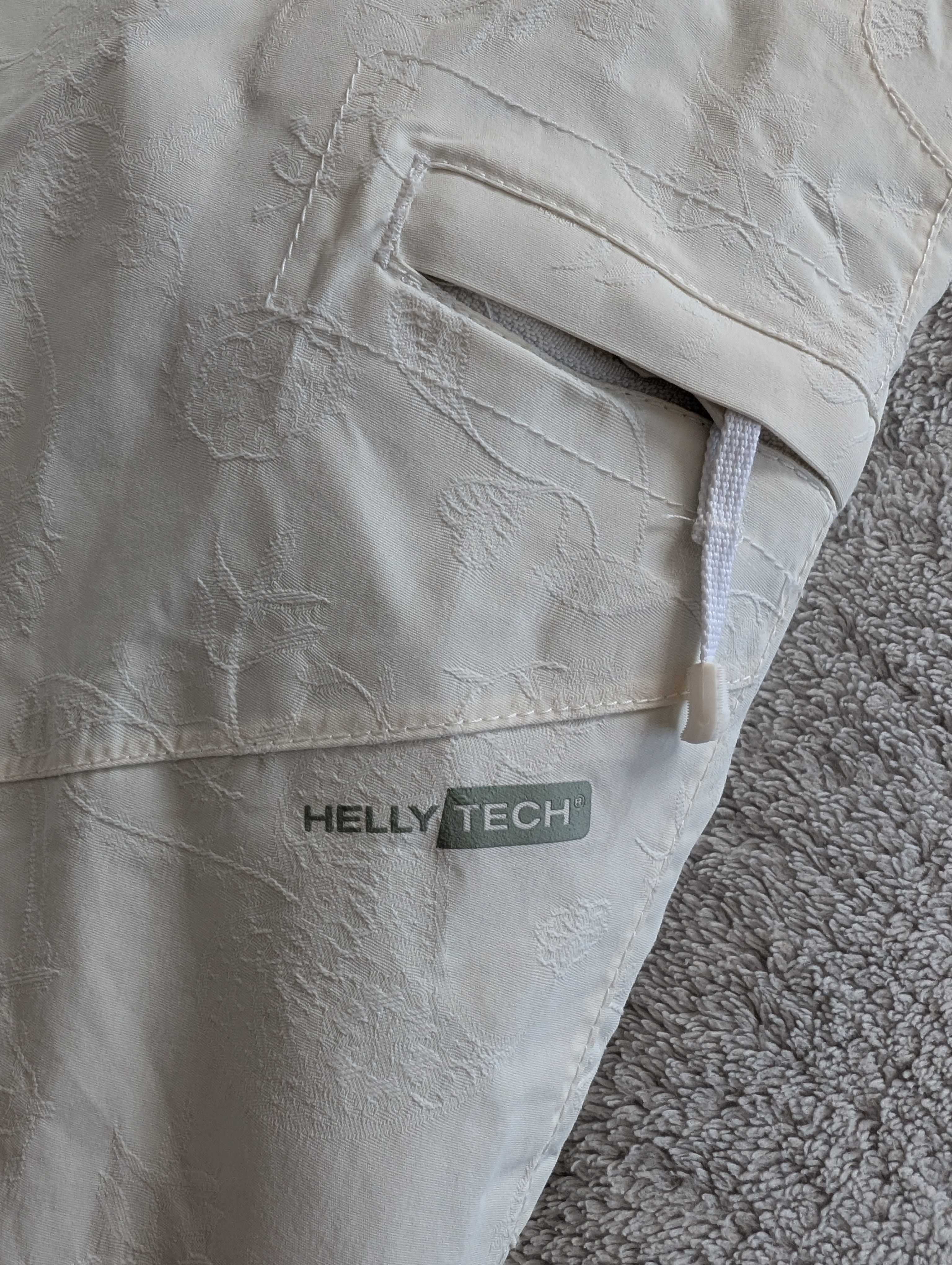 Kremowe spodnie narciarskie haftowane w kwiatki Helly Hansen Tech M 38
