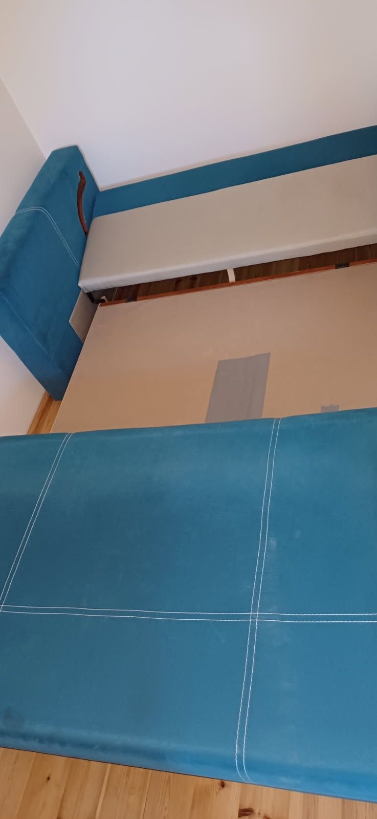 Turkusowa sofa z funkcją spania i pojemnikiem na pościel