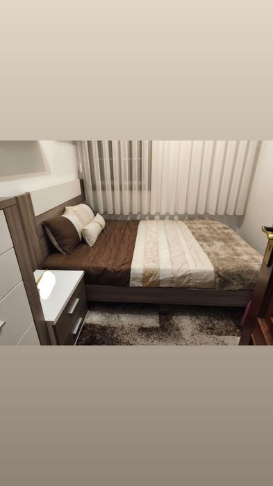 Quarto completo,  com detalhes em castanho e branco.