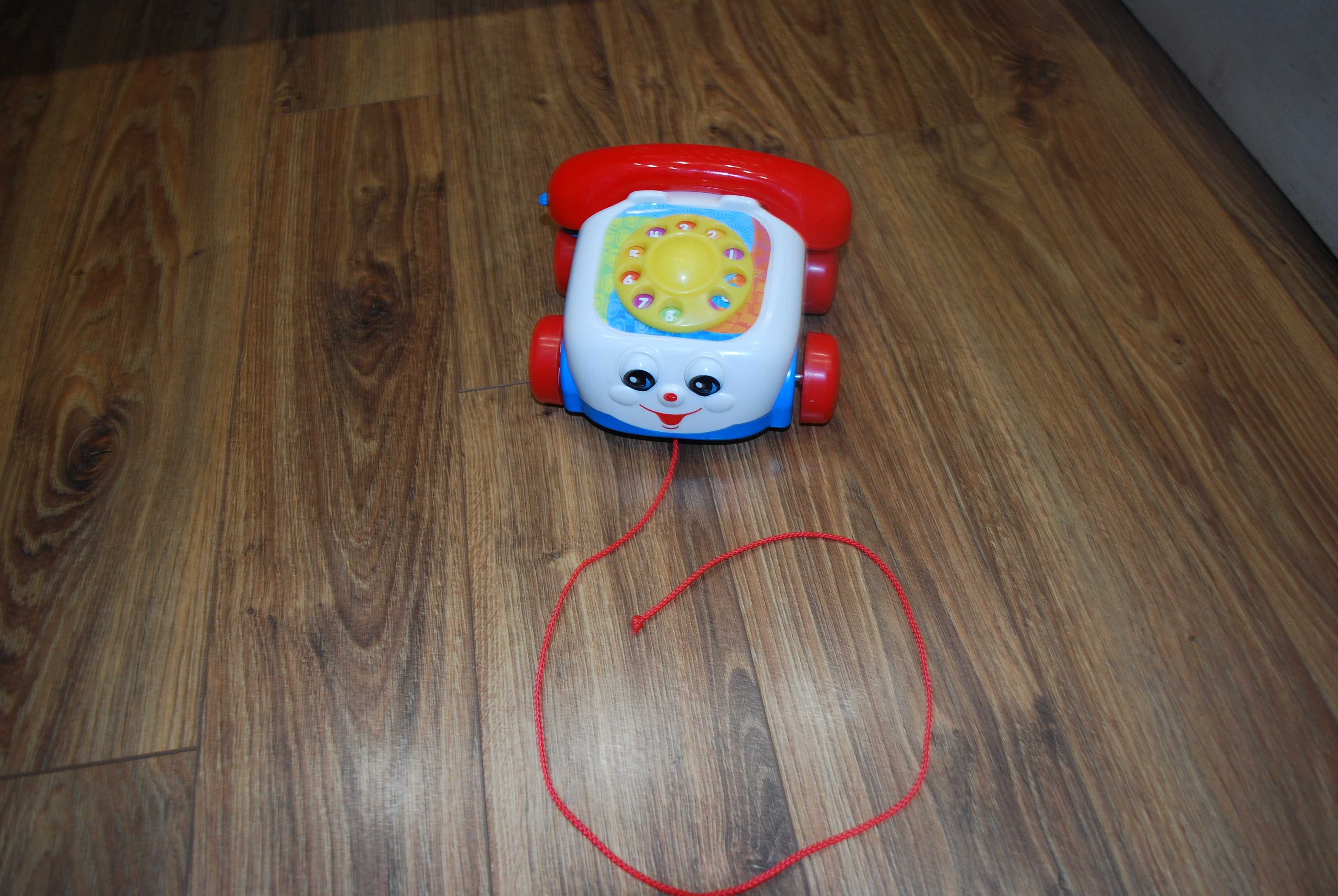 Fisher Price - jeżdżący telefon z oczkami