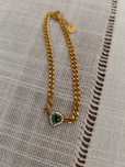 Pulseira dourada com pedra verde
