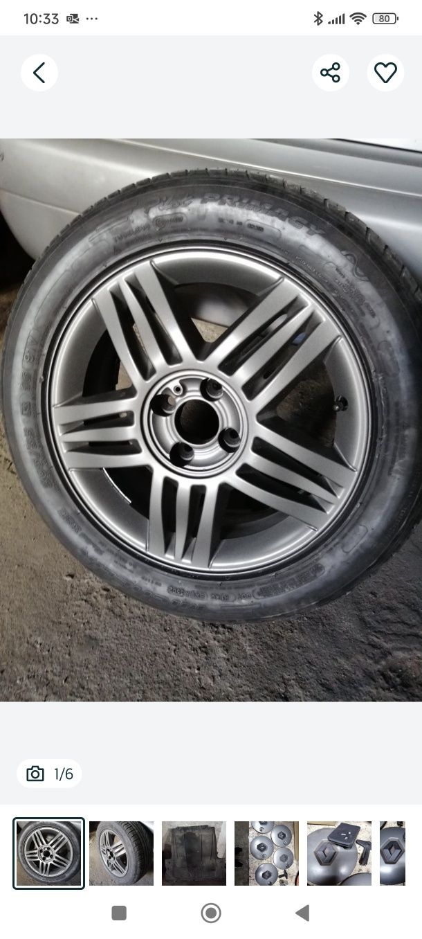 Jante Renault Megane ll com pneu, e tampas com parafusos e chave.