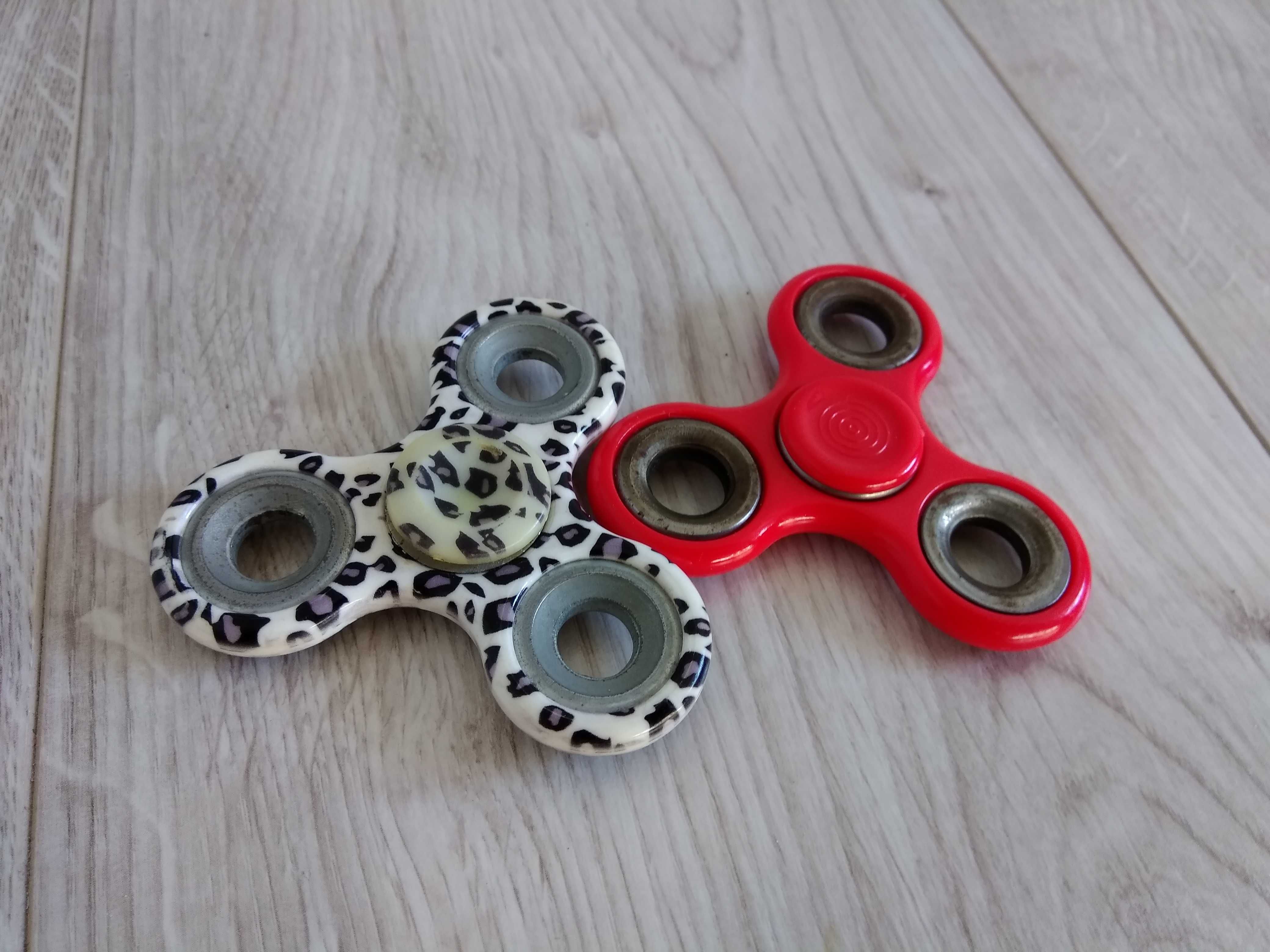 2 fidget spinnery, w panterkę i czerwony