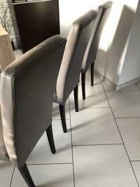 Wygodne krzesła ze skóry naturalnej w kolorze taupe .