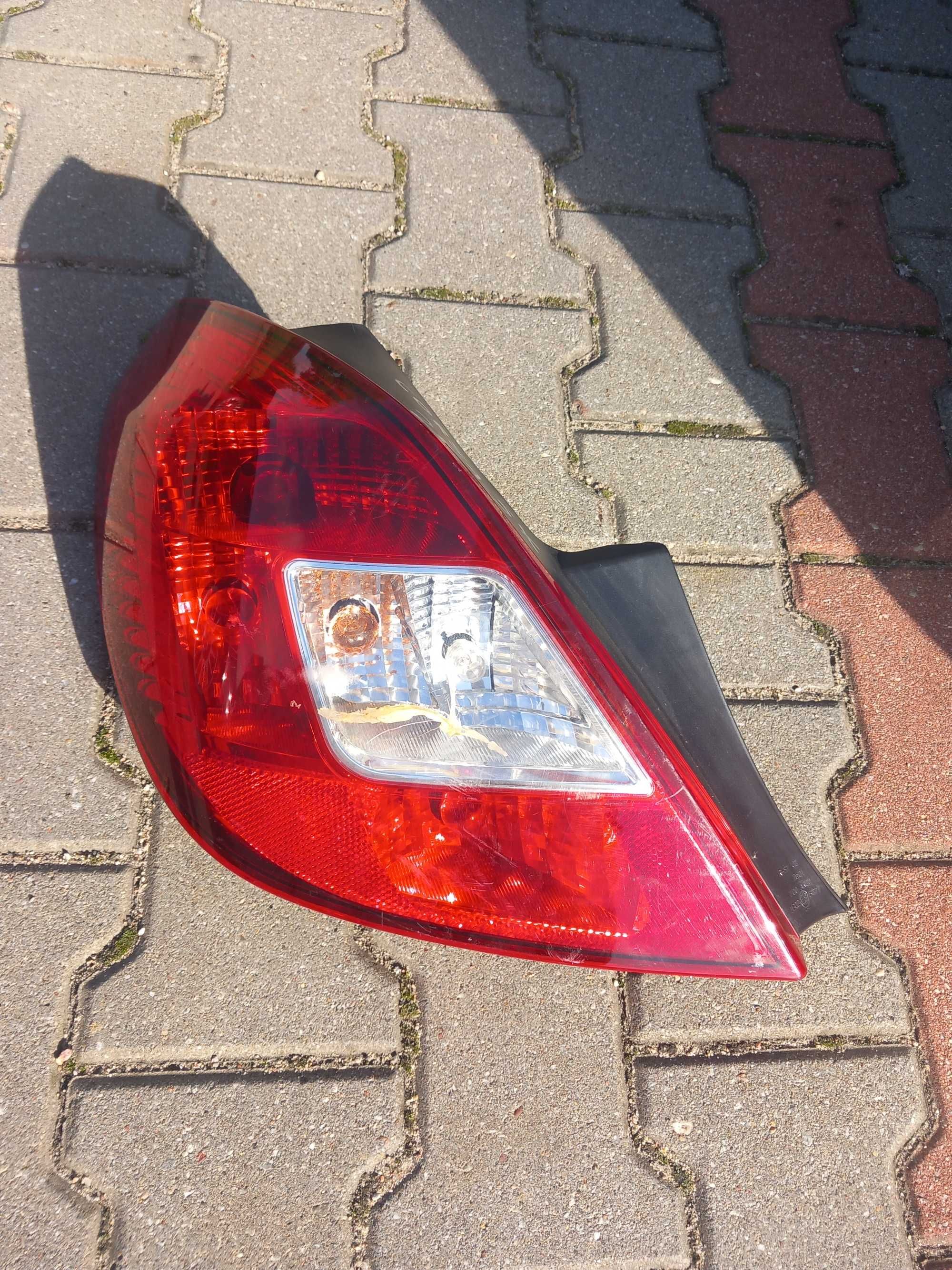 Lampa tył opel corsa d lewa reflektor lewy pajączek