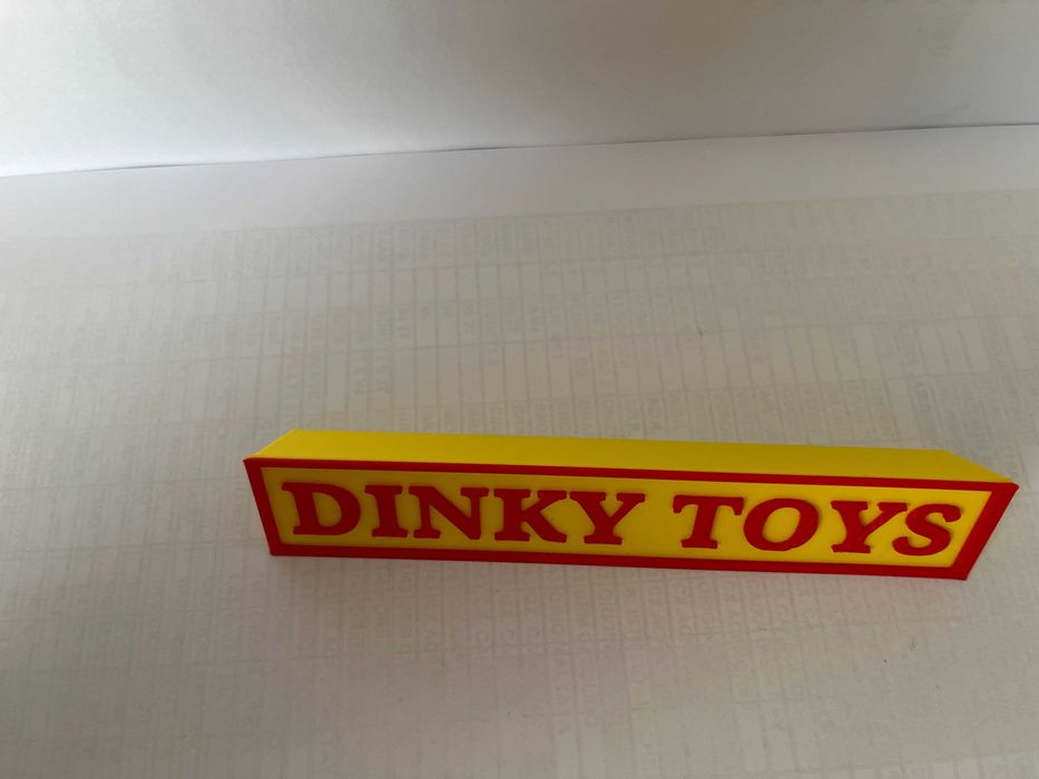 Sinal DINKY TOYS p/expositor miniaturas, paral. triang.reg., amarelo