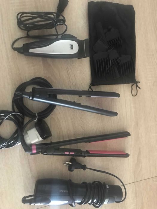dois alisadores um secador e uma maquina de cortar cabelo usados