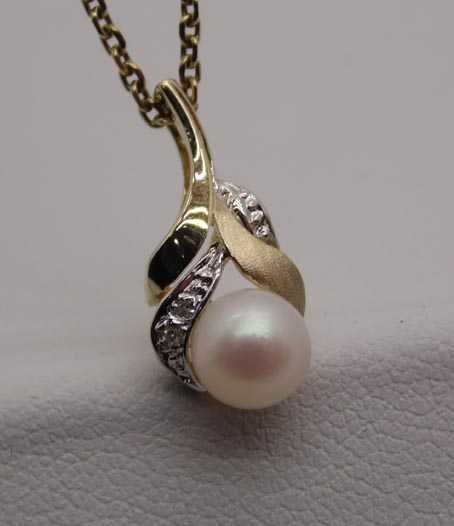 Delikatna złota zawieszka perła i diamenty.