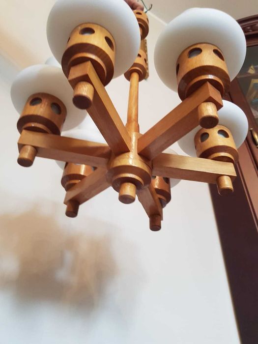 Stary żyrandol drewniany z białymi kloszami