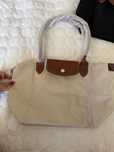 Longchamp, nowa, w kolorze mlecznym.