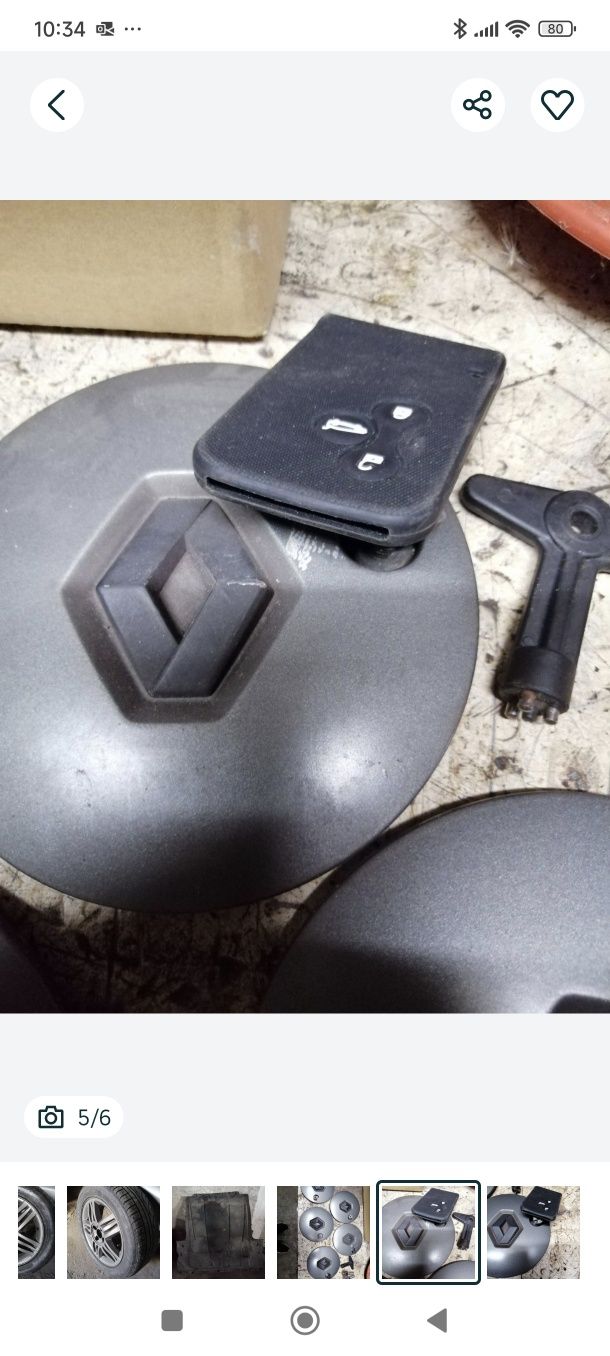 Jante Renault Megane ll com pneu, e tampas com parafusos e chave.