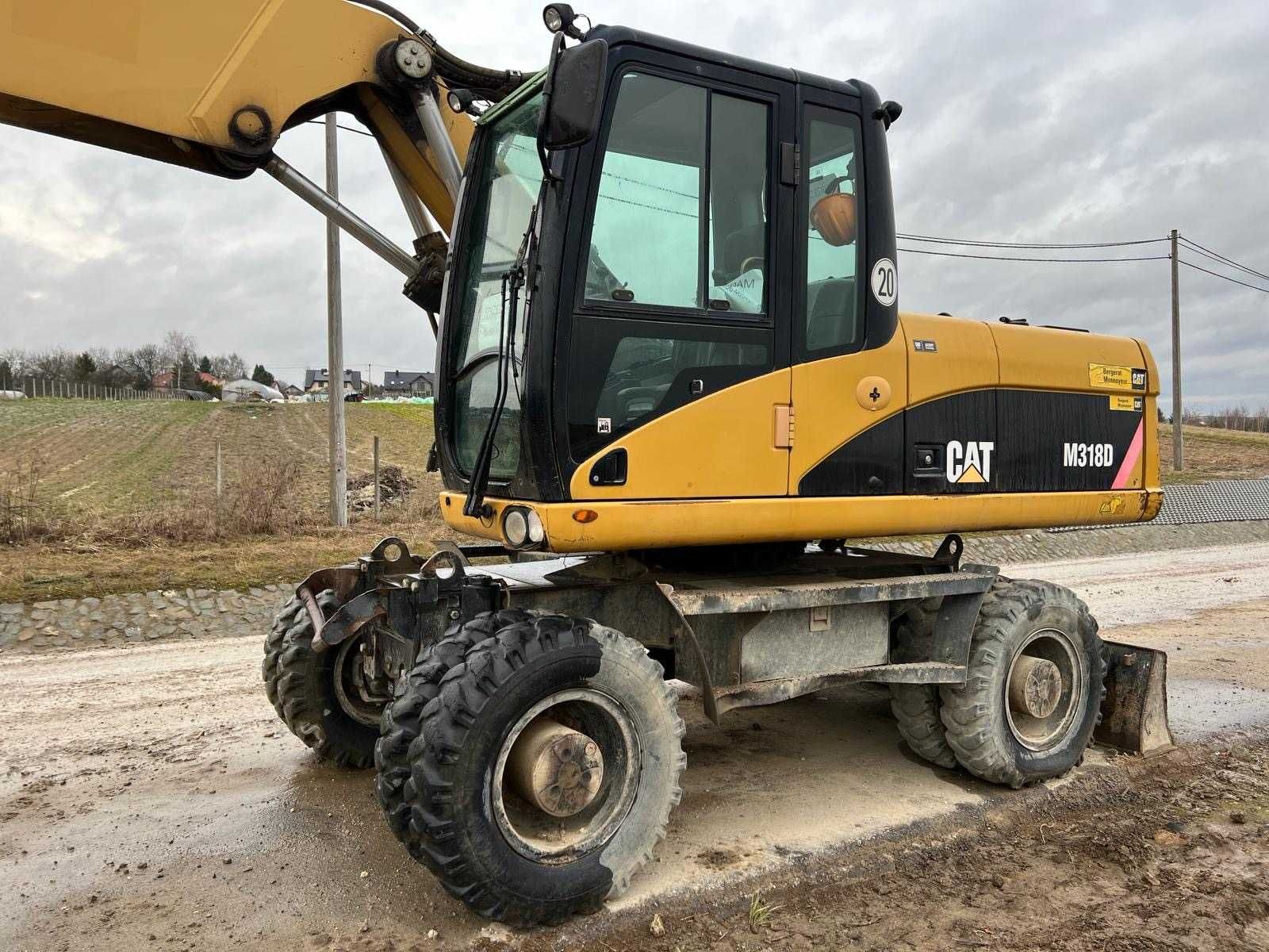 Koparka Caterpillar M318D. Pług, hydrauliczna łyżka skarpowa. Fv.