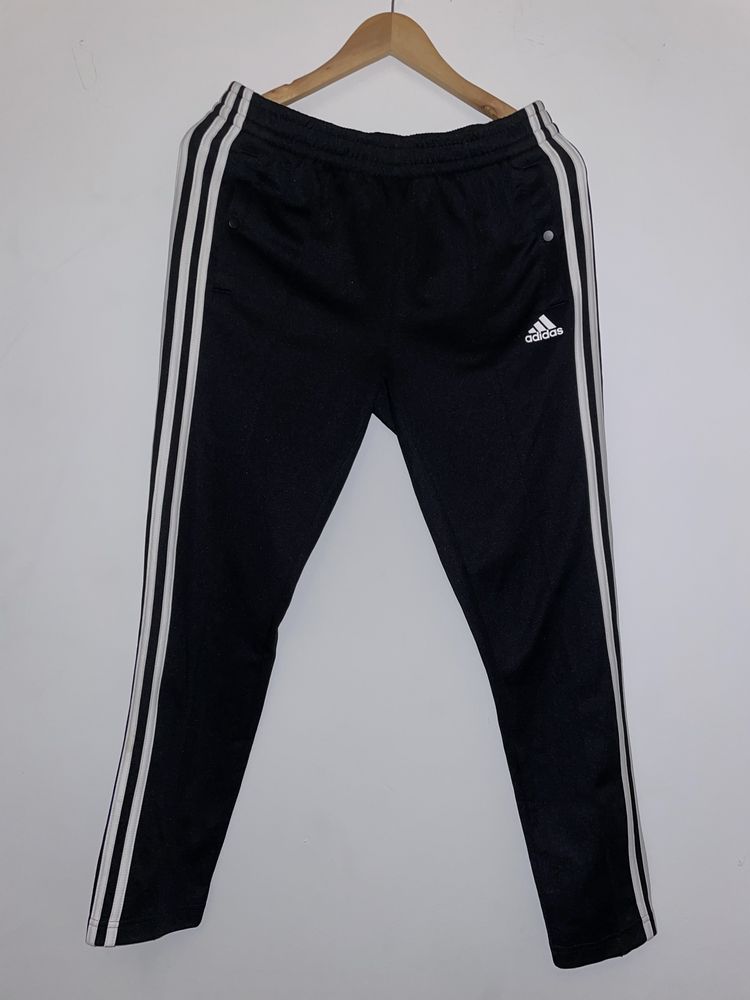 Damskie spodnie sportowe Adidas rozpinane po bokach