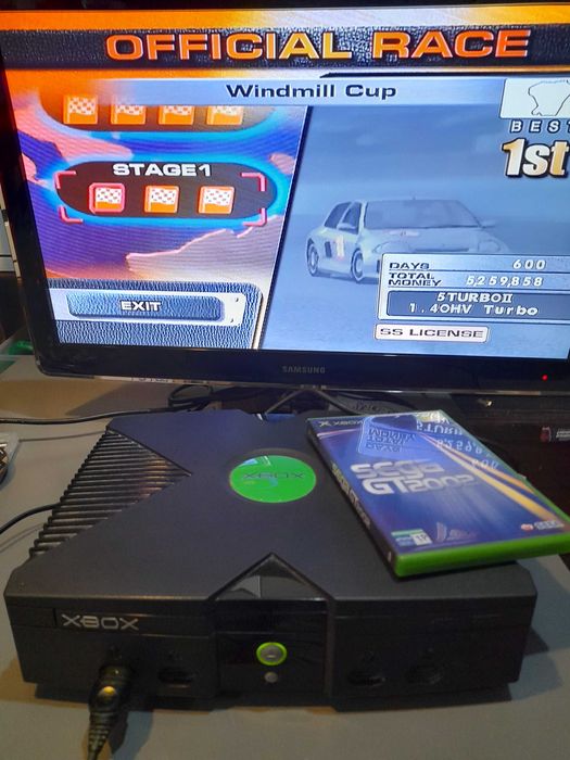 Consola de jogos X-BOX antiga desbloqueada usada com cabos e comando.