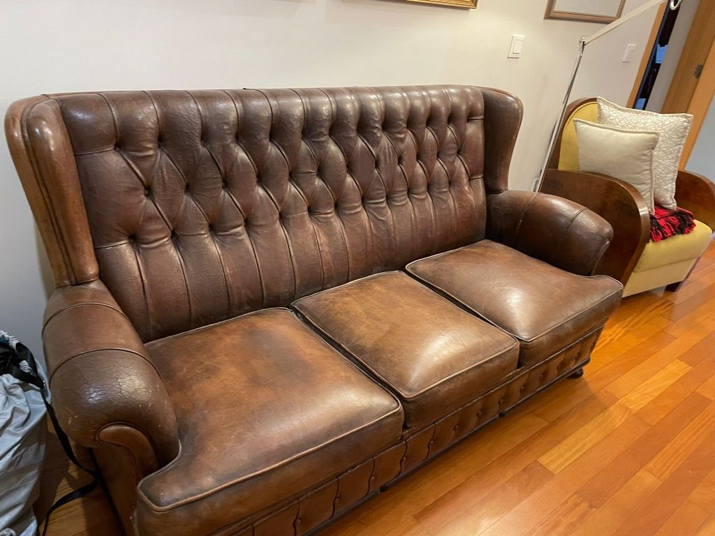 Sofá estilo Chesterfield com a pele envelhecida