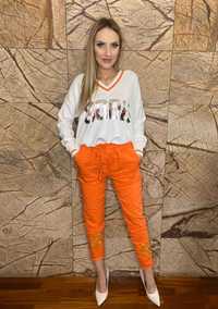 Spodnie gnieciuchy kolor pomarańczowy, ozdobna nogawka