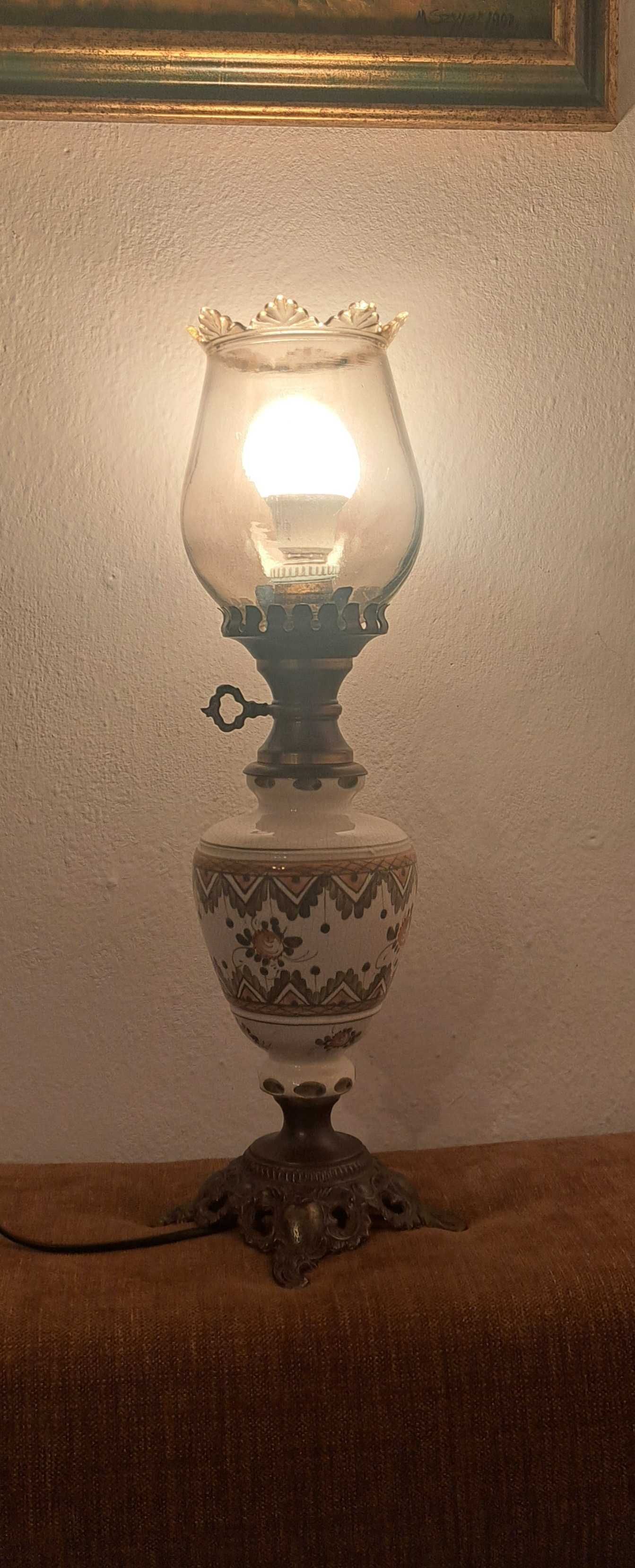 dwie mosiężno - porcelanowe wysokie lampy stylizowane na naftowe