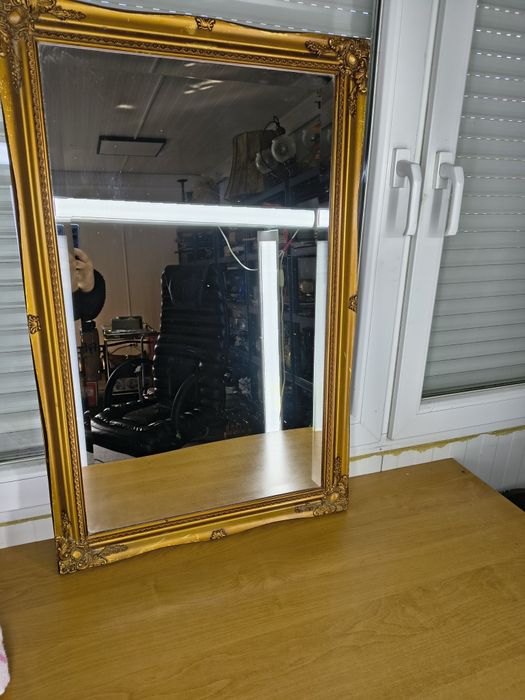 Lustro w ozdobnej złotej ramie
