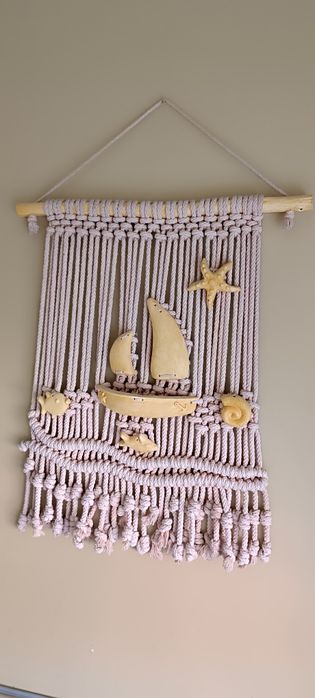 Peça decorativa macramé com barcos em amarelo . Usado