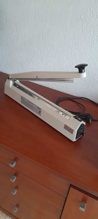 Máquina  de selar/fechar sacos de plástico até  20  cm de largura.