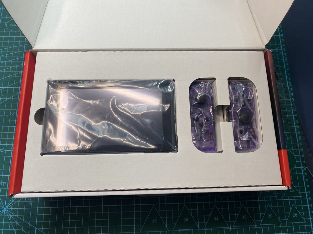 Nintendo Switch V2 - gałki magnetyczne, karta pamieci i fioletowy kolo