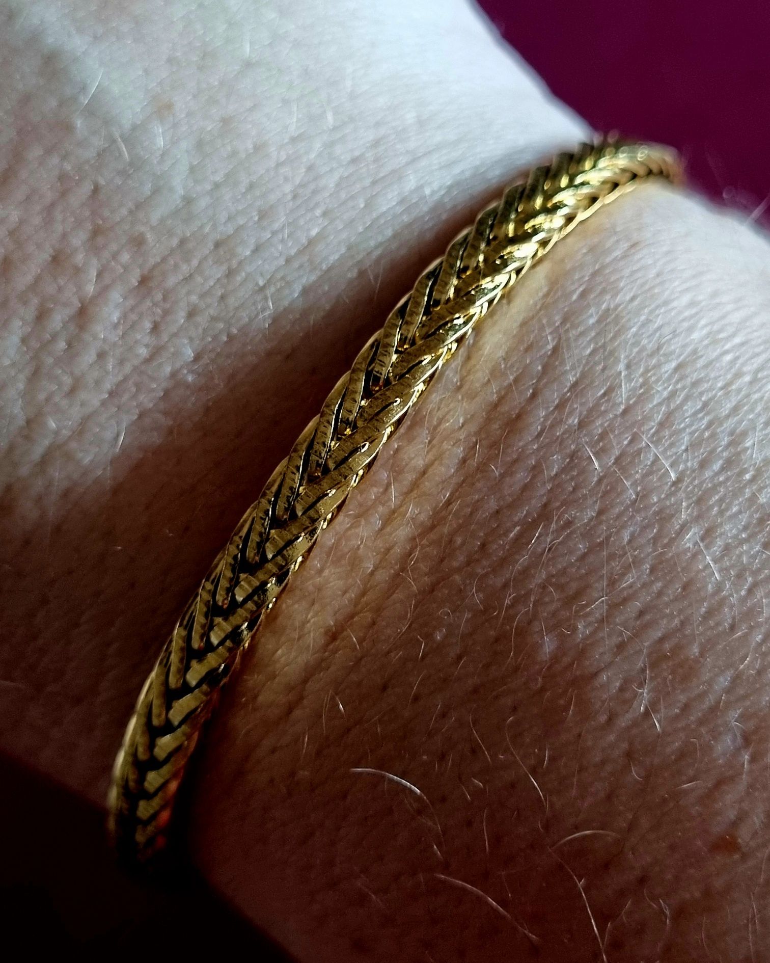 Pulseira dourada, em aço inoxidável. Tem extensor