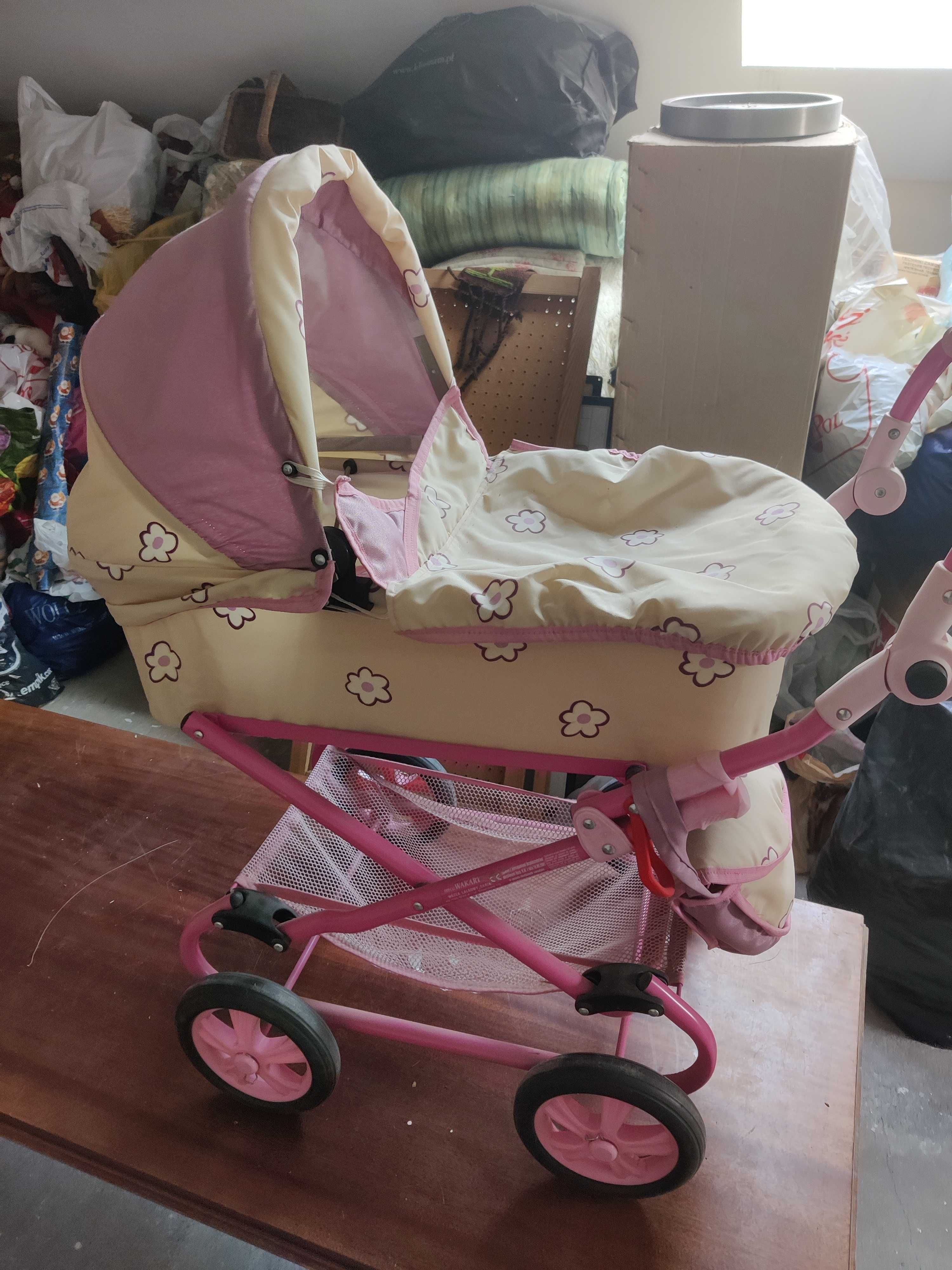 Różowy wózek dla lalek z regulacją wysokości uchwytu