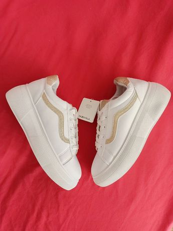 Білі кросівки з золотою вставкою