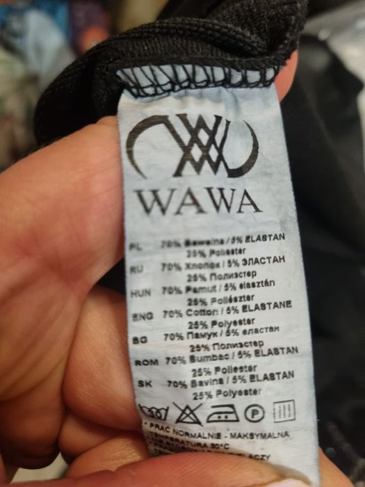 Śliczna czarna bluzka ozdobiona aplikacją w kształcie kota z cekinów.