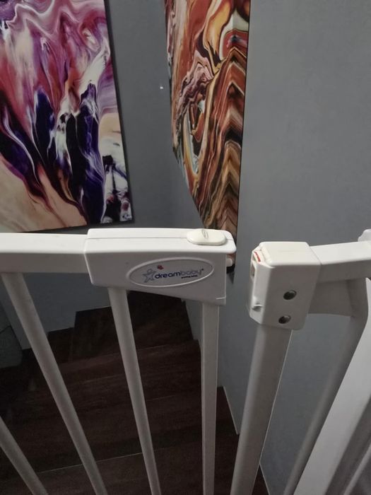 Bramka zabezpieczają długa biała, rozporowa, zabezpieczenie dla dzieci