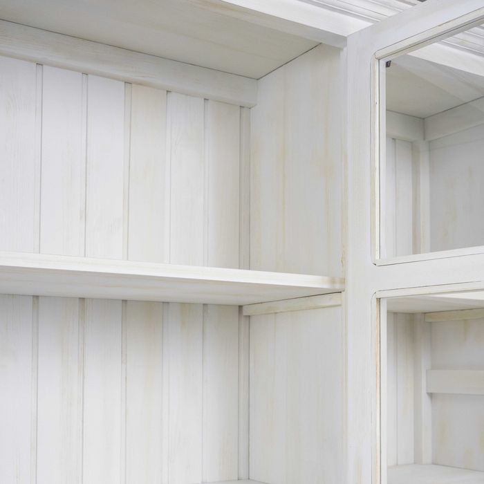 Biała witryna trzydrzwiowa na książki z szufladami do salonu