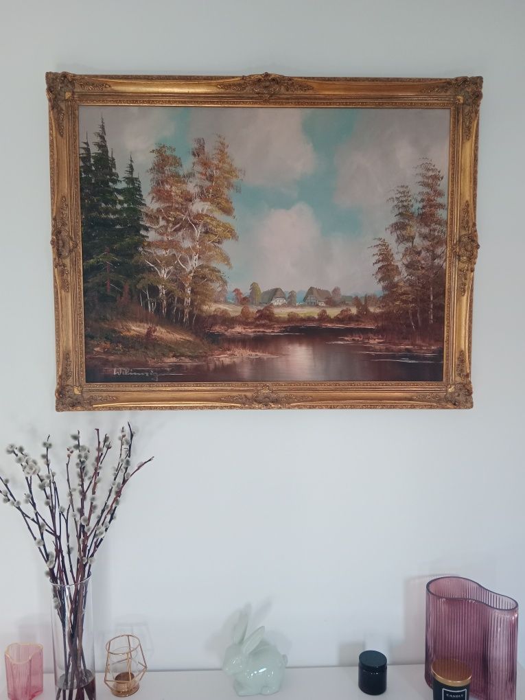 Pejzaż domów na tle jeziora. Obraz w ramie 92x71