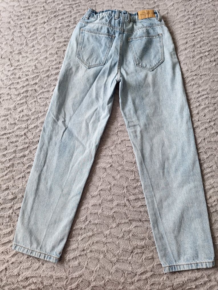 Spodnie dżinsowe z dziurami dziewczęce rozmiar 140